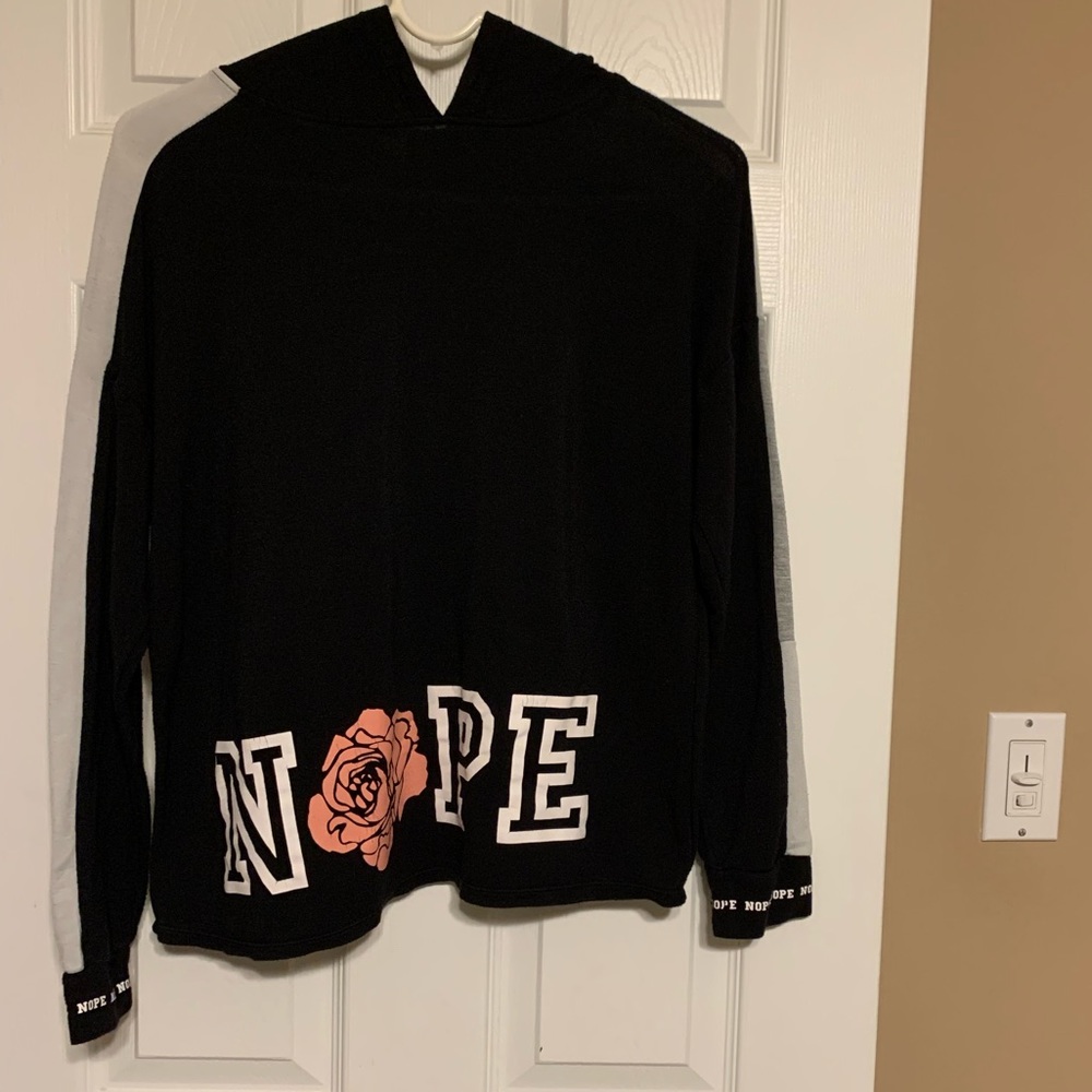 No boundaries shirt with hood. Says Nope on bottom front and on one shoulder.